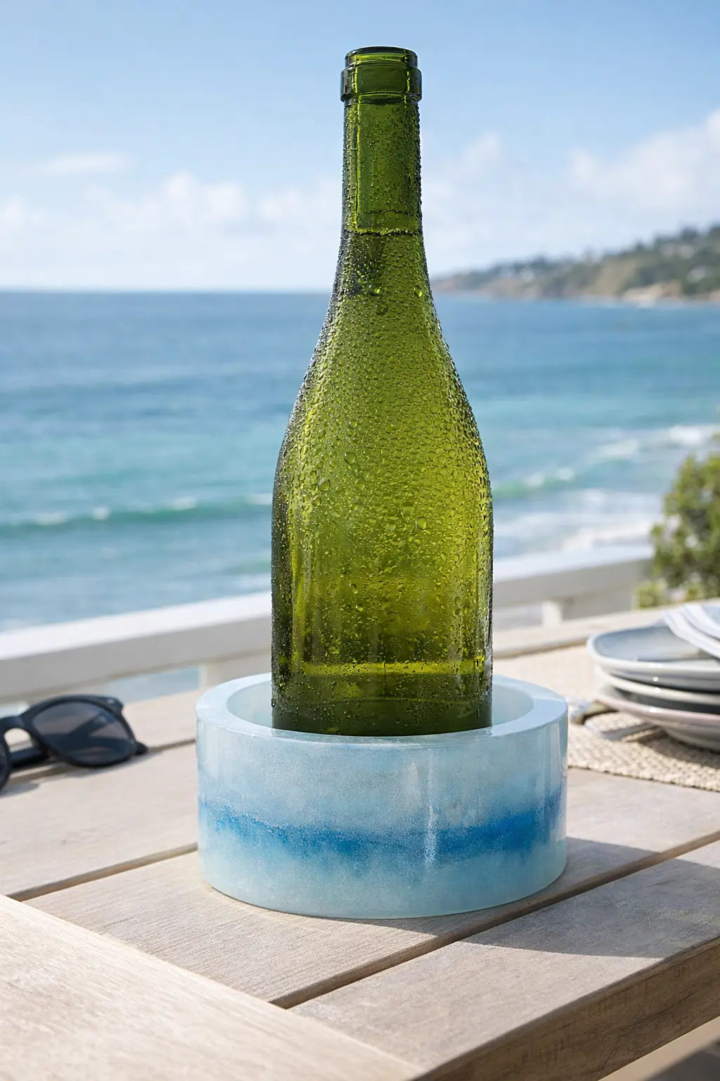 Resin bottle coaster catching condensation from wine bottle
