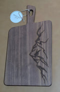 Walnut-finished acacia serving board with angular mountain ridge engraving along the right edge