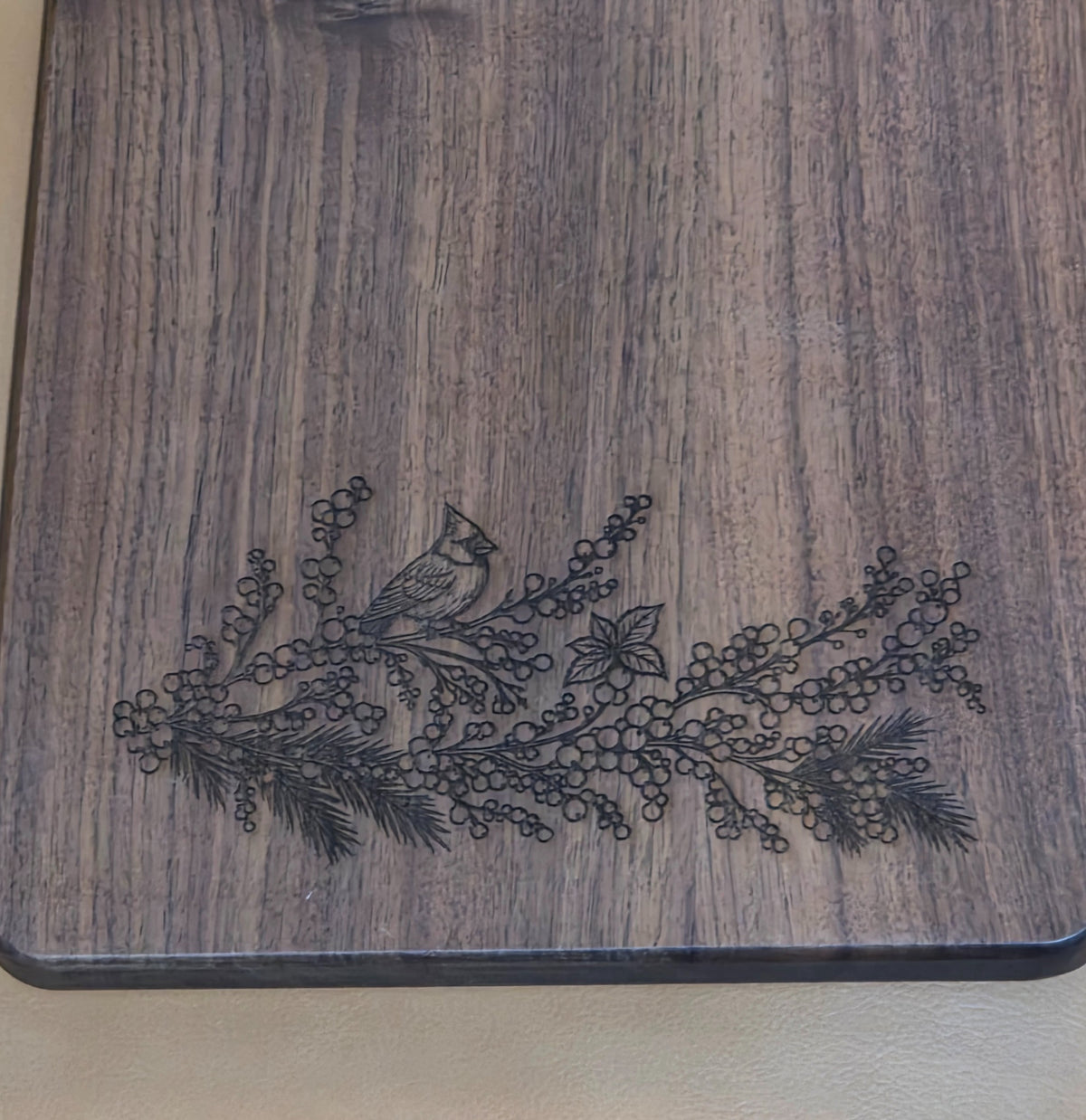 Detail of cardinal and winter berry branch engraving
