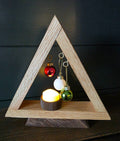 White oak triangular Christmas tree on a dark walnut base with hanging ornaments and glowing LED tea light