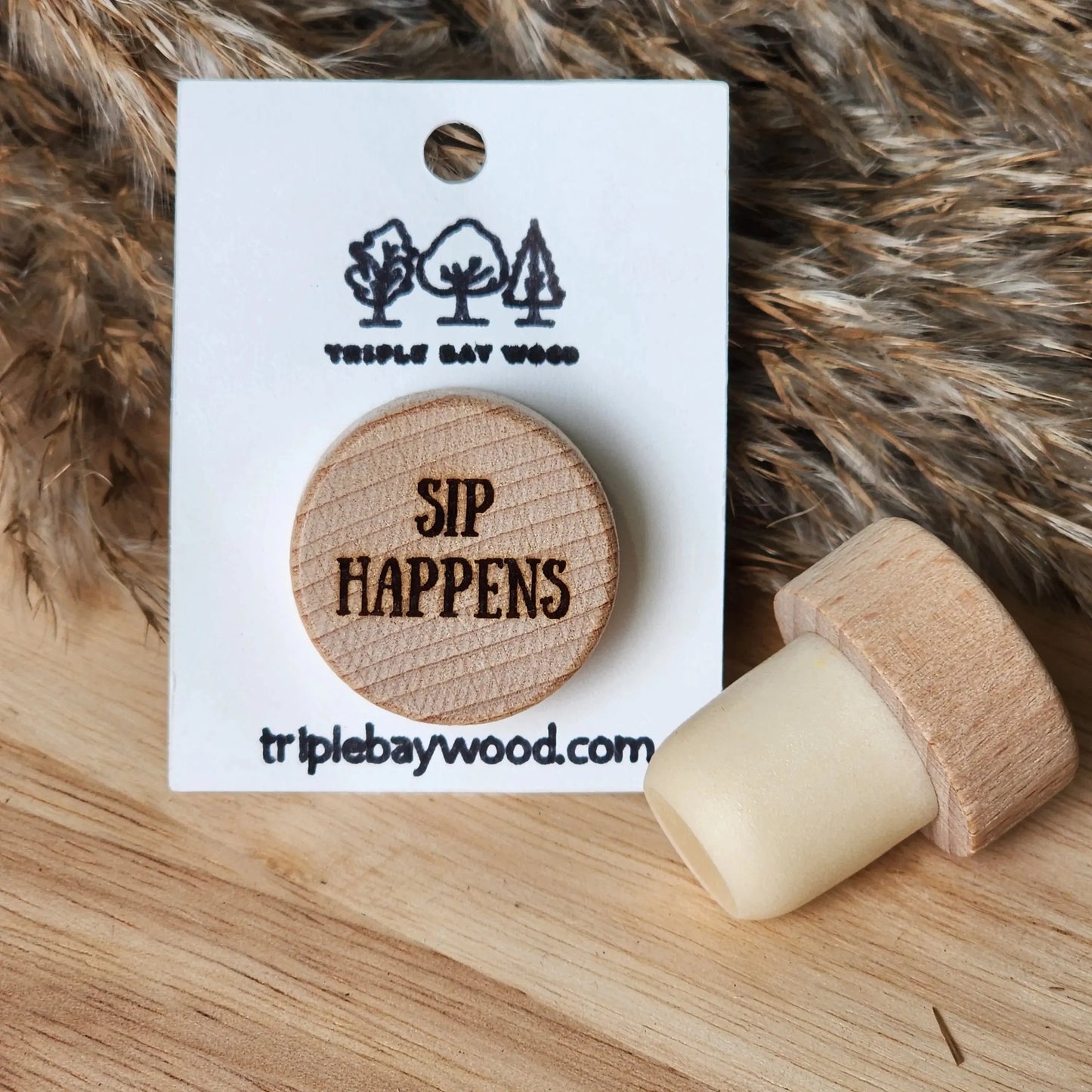 Wood wine bottle stopper with engraved 'SIP HAPPENS' on display card, resin and wood décor.