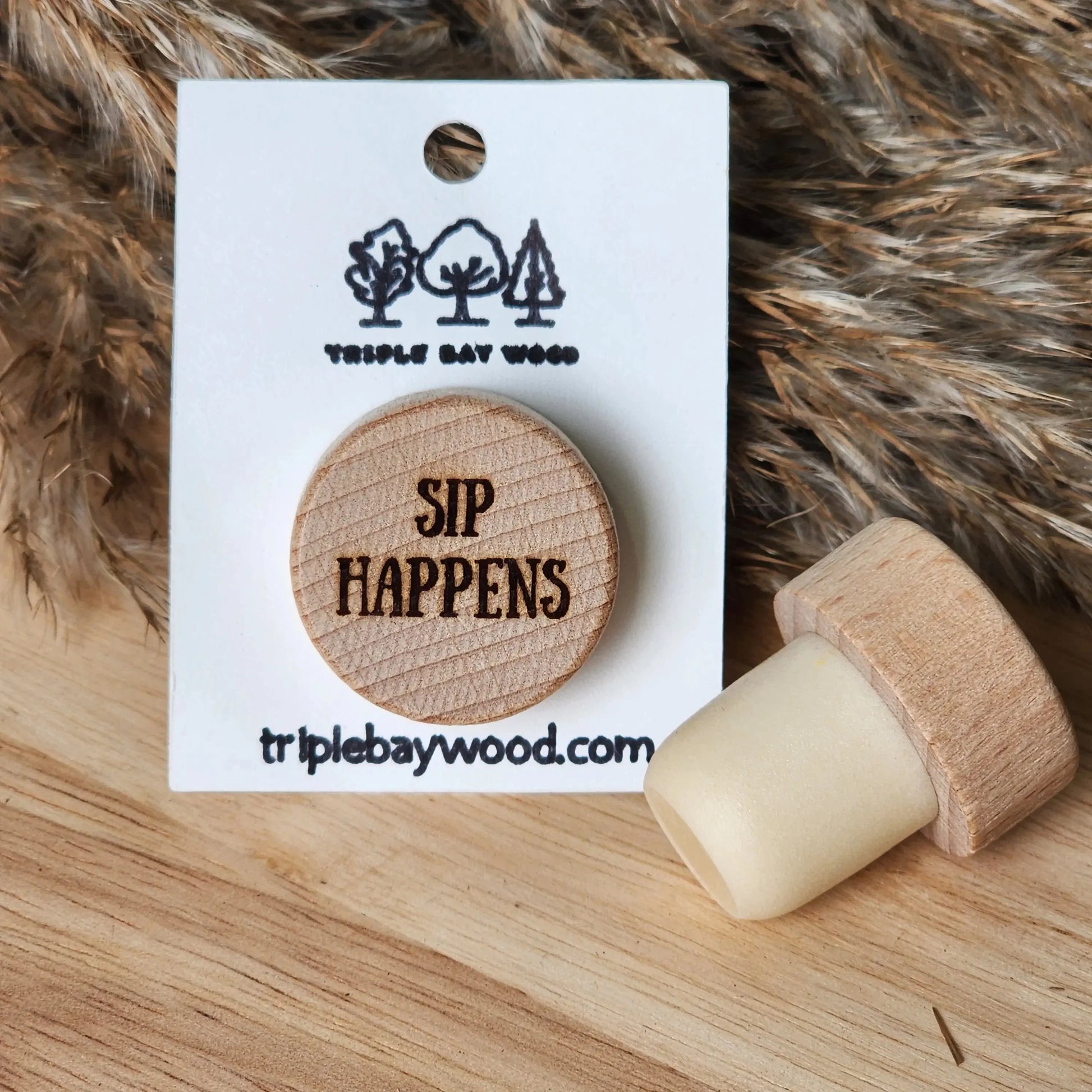 Wood wine bottle stopper with engraved 'SIP HAPPENS' on display card, resin and wood décor.