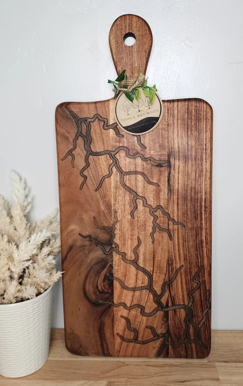 Handcrafted wood and resin serving board with natural grain and unique branch pattern