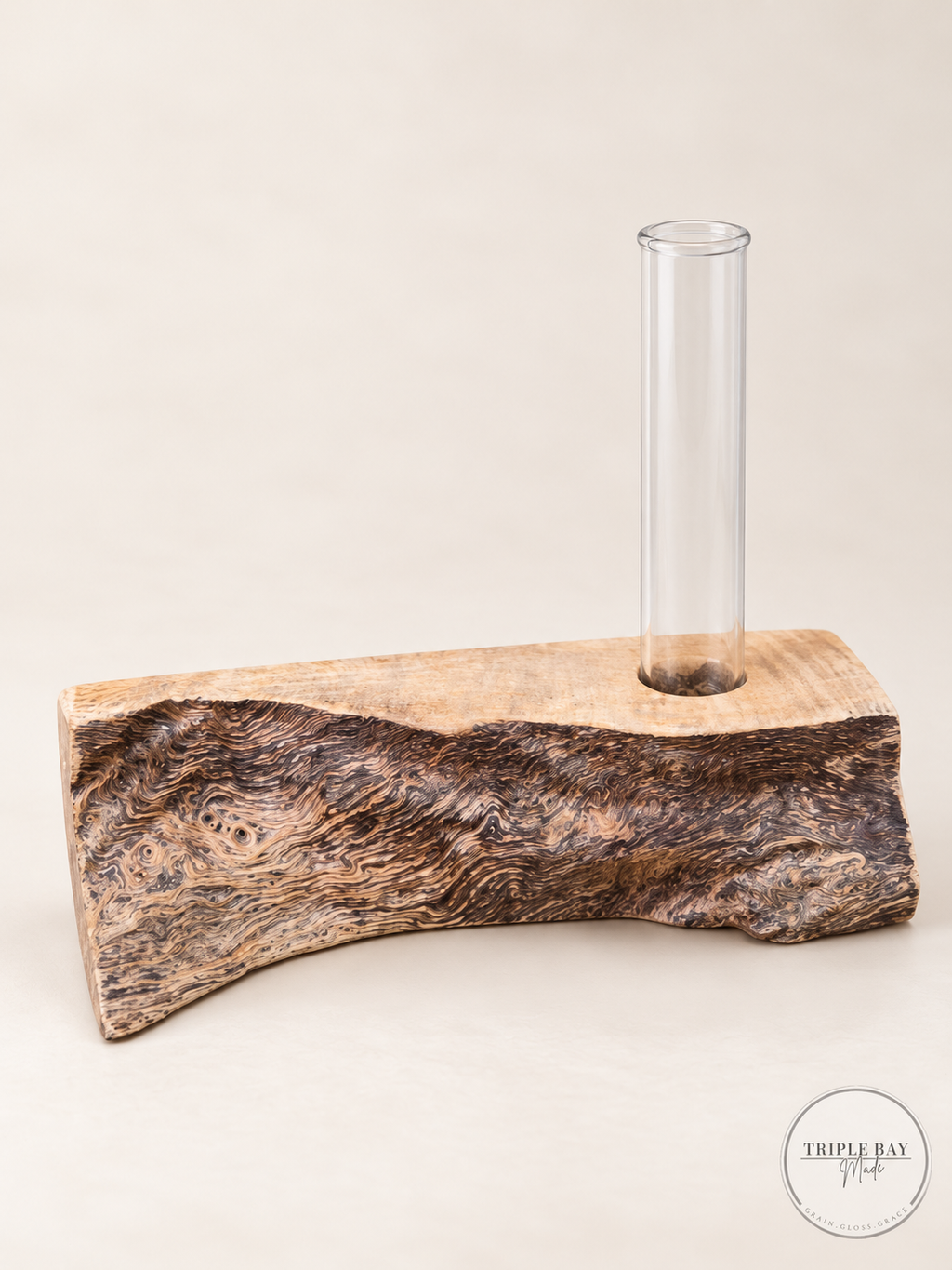 Live edge burl wood propagation holder with clear glass test tube and swirling dark grain