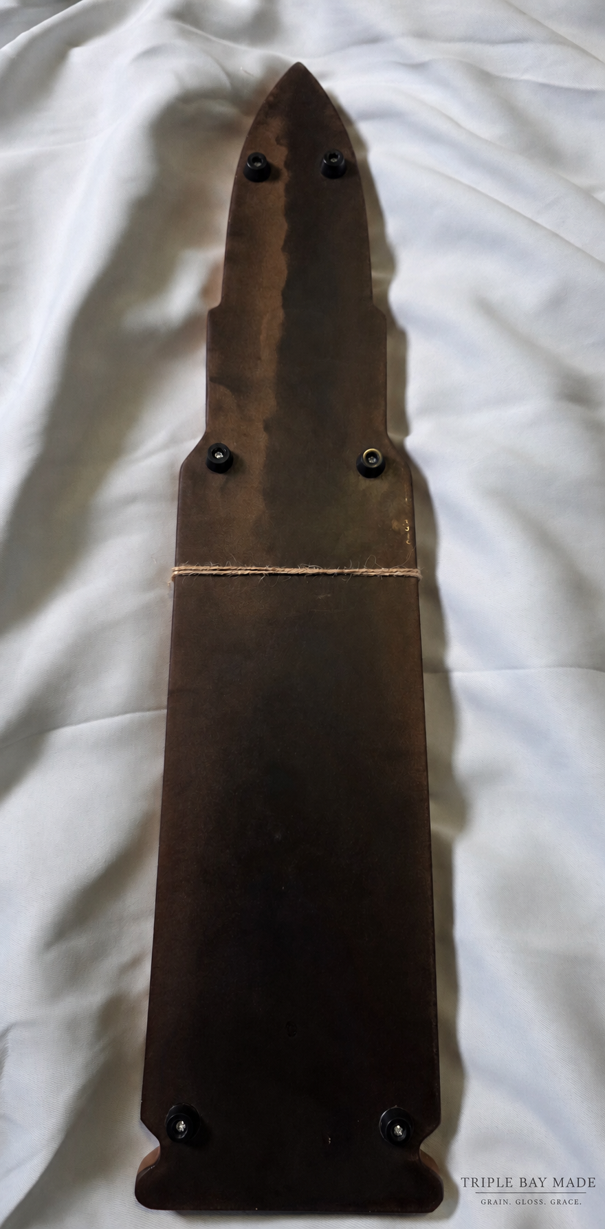 Underside of Copper Ember walnut resin serving board showing protective feet