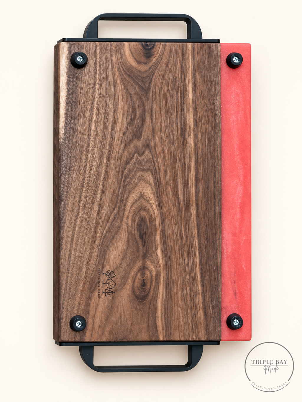 Back of walnut and coral-red resin tray showing four feet and Triple Bay Wood maker mark