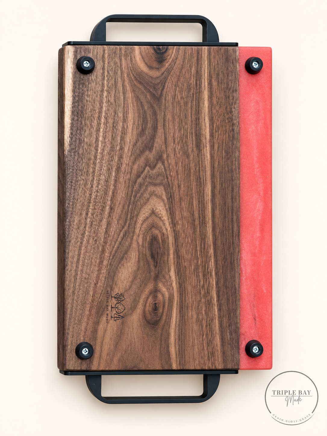Back of walnut and coral-red resin tray showing four feet and Triple Bay Wood maker mark