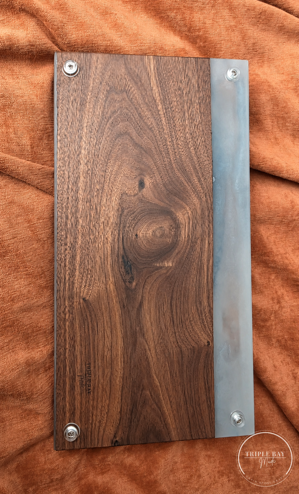 Back of Dragon Eye walnut and resin serving board with raised clear feet