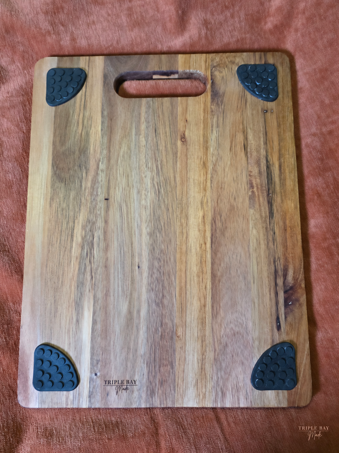 Back of Evergreen Trio acacia board showing four feet and maker stamp