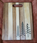 Evergreen Trio acacia resin cutting board front with three tree inlays