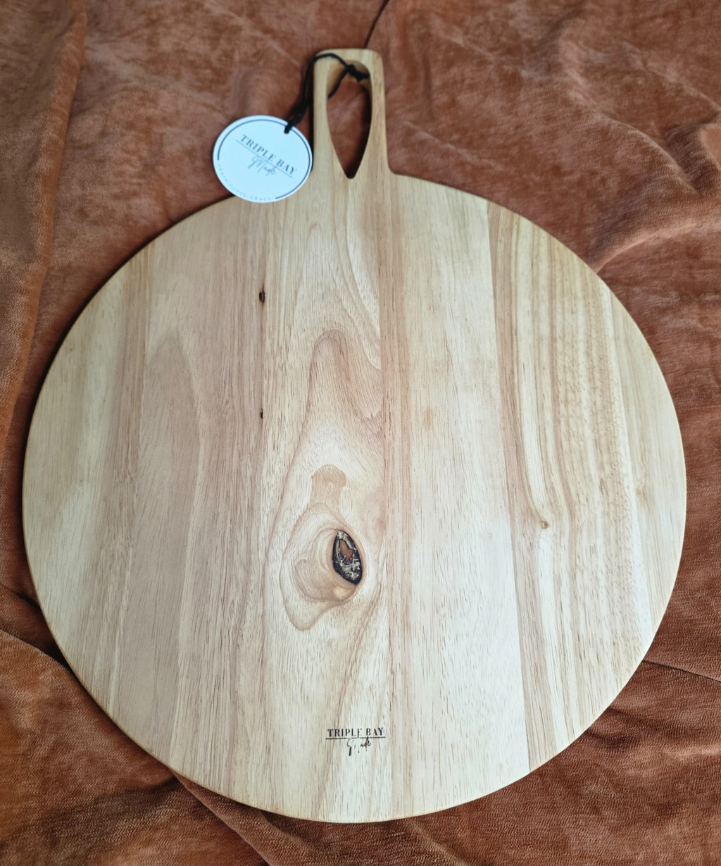Back of natural rubberwood round paddle serving board