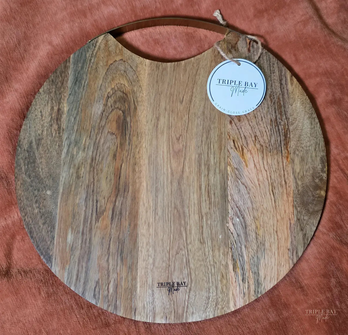 Back of Golden Birds acacia board with brass handle and maker mark
