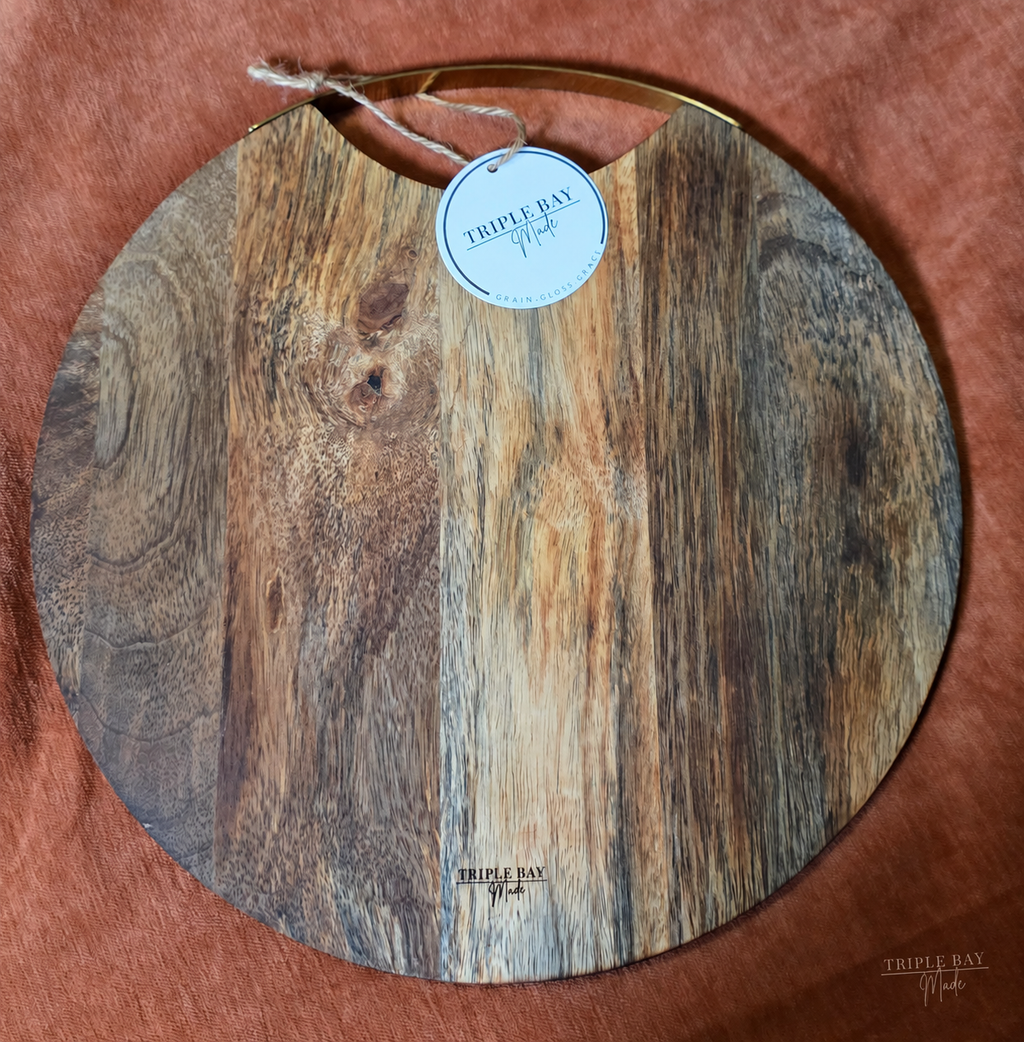 Back of Golden Evergreens acacia serving board with brass handle and maker mark