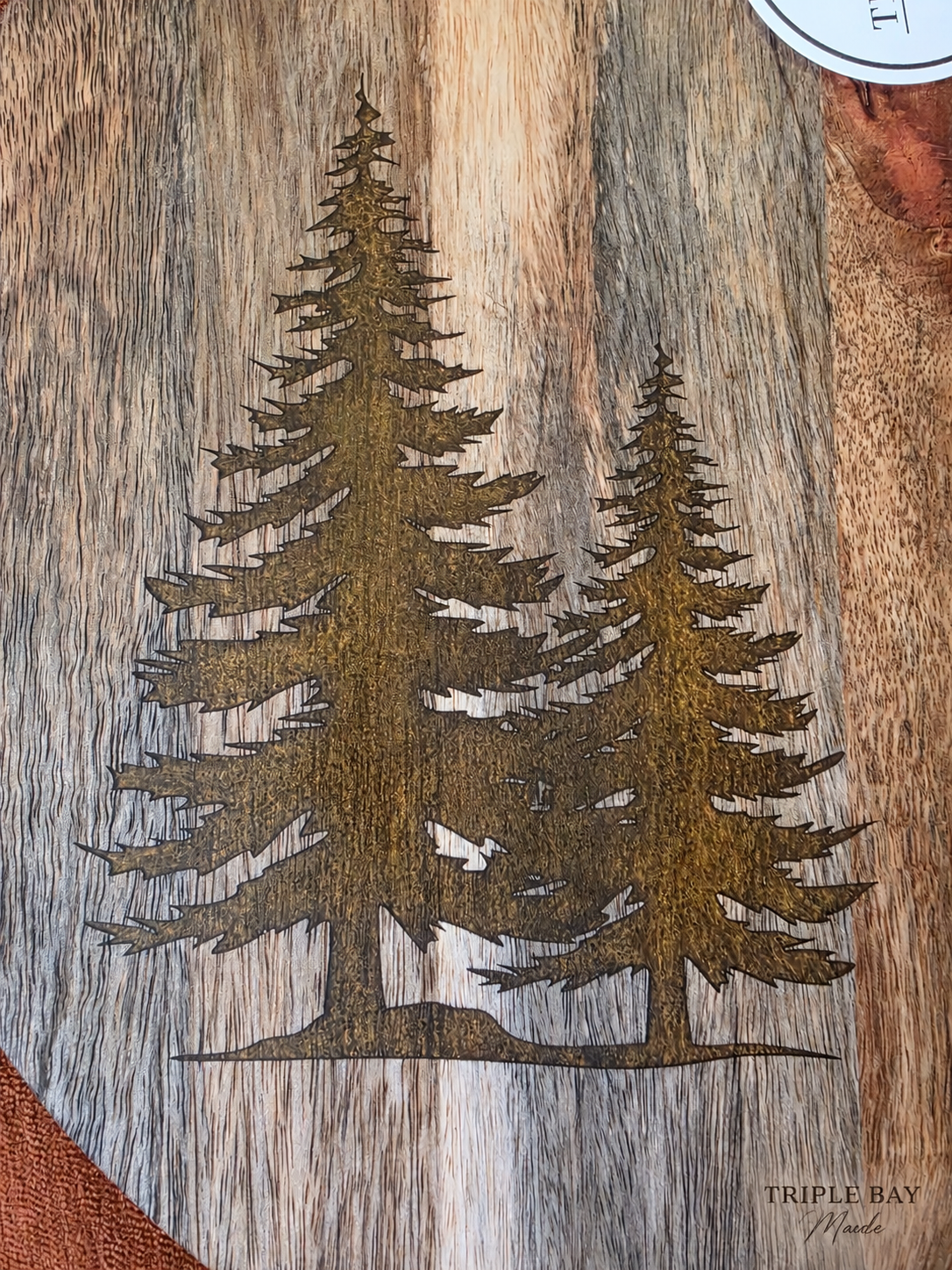 Close-up of intricate golden evergreen resin inlays in acacia