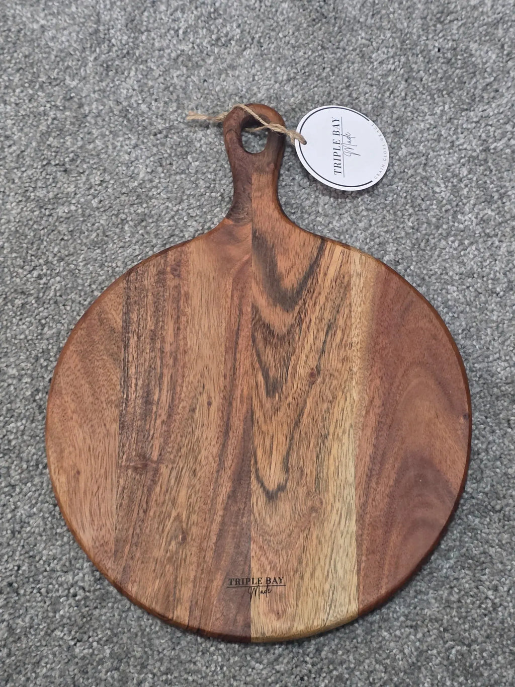 Reverse of Meadow Edge acacia board showing natural grain, handle and Triple Bay Made maker mark