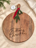 Merry Christmas engraved acacia serving board on ivory stone beside neutral linen