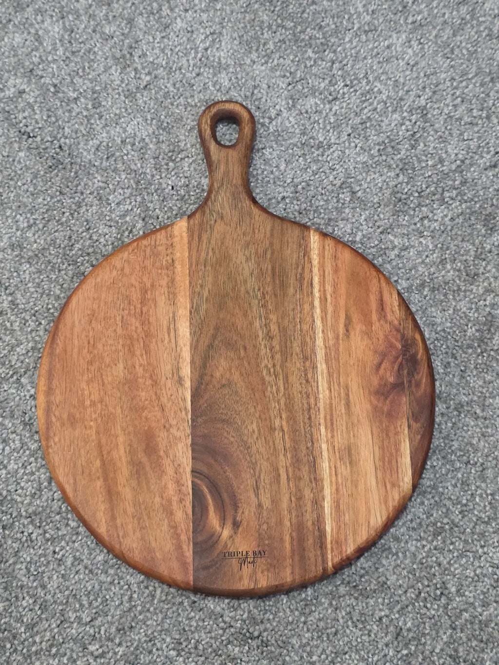 Reverse of Sunflower Calf acacia board showing natural grain, handle and Triple Bay Made maker mark