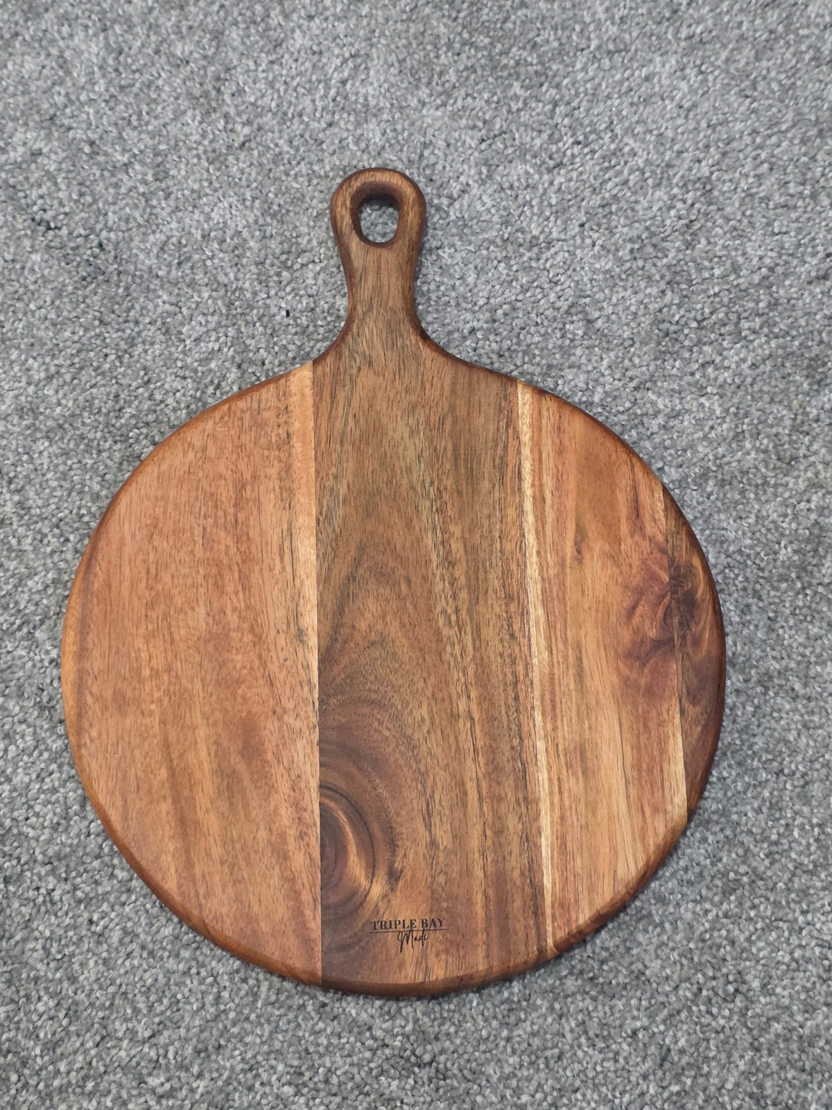 Reverse of Sunflower Calf acacia board showing natural grain, handle and Triple Bay Made maker mark