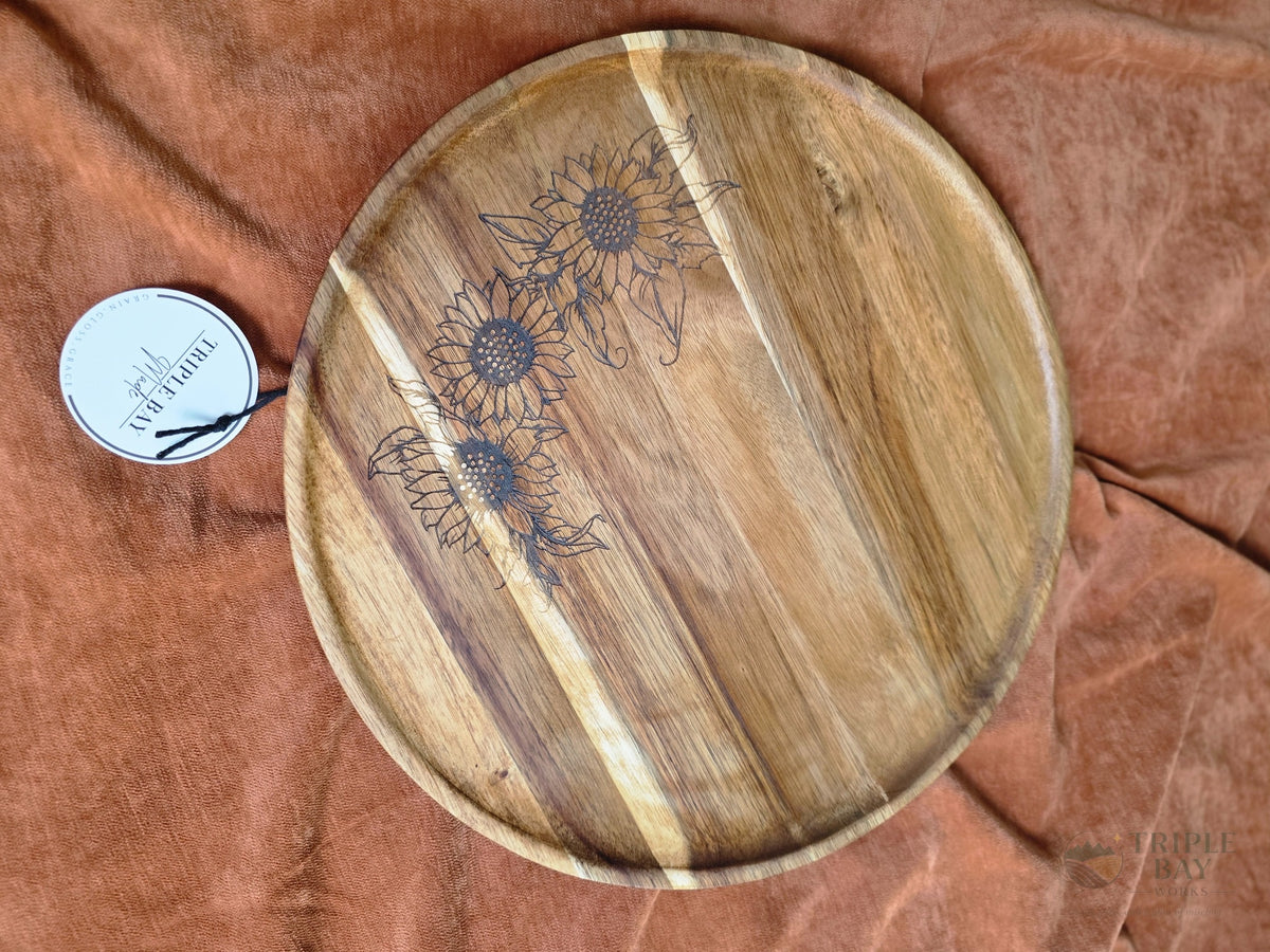 Round acacia lazy Susan engraved with three detailed sunflowers