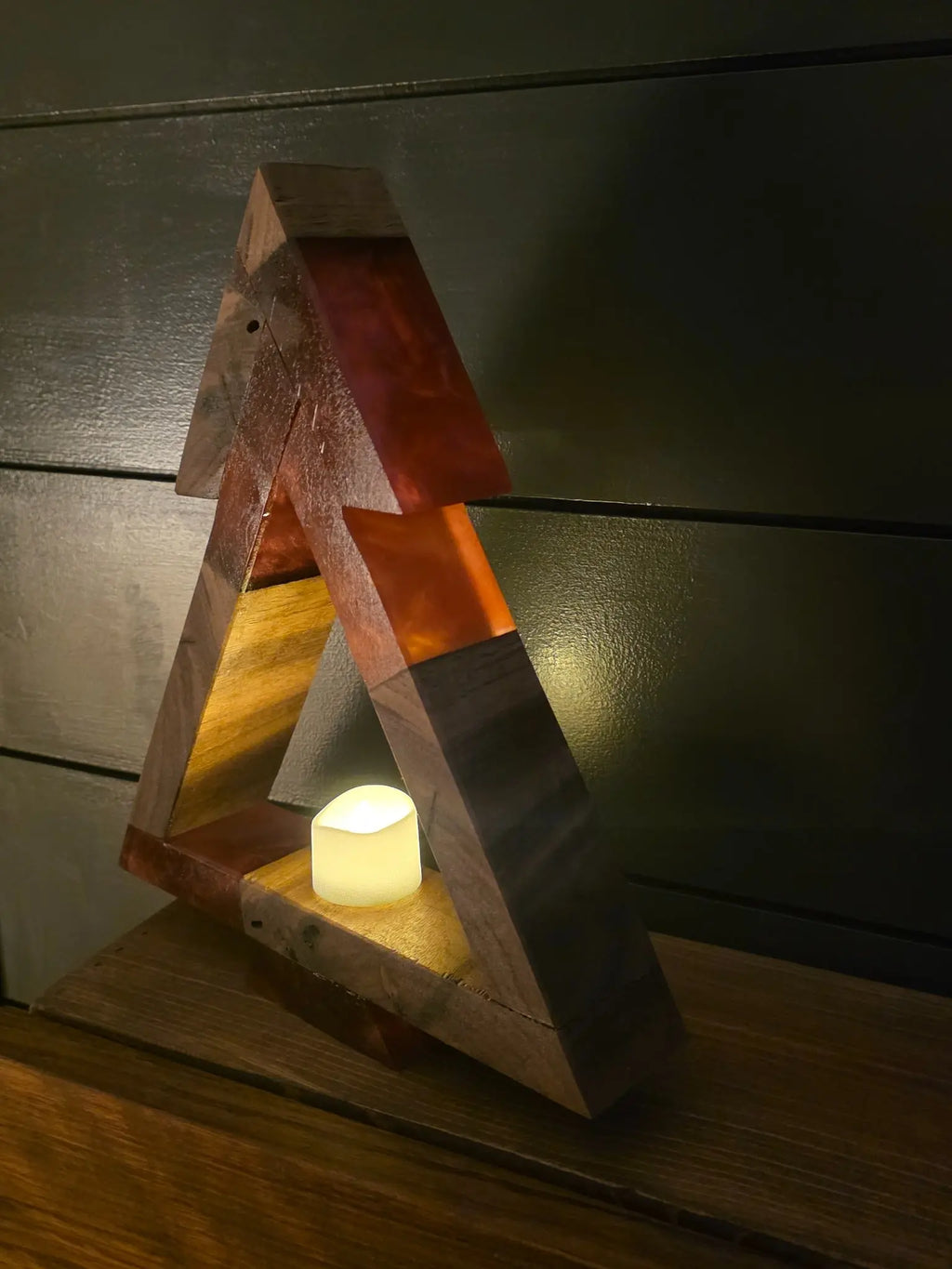Closeup of red resin and walnut tree illuminated by LED tea light