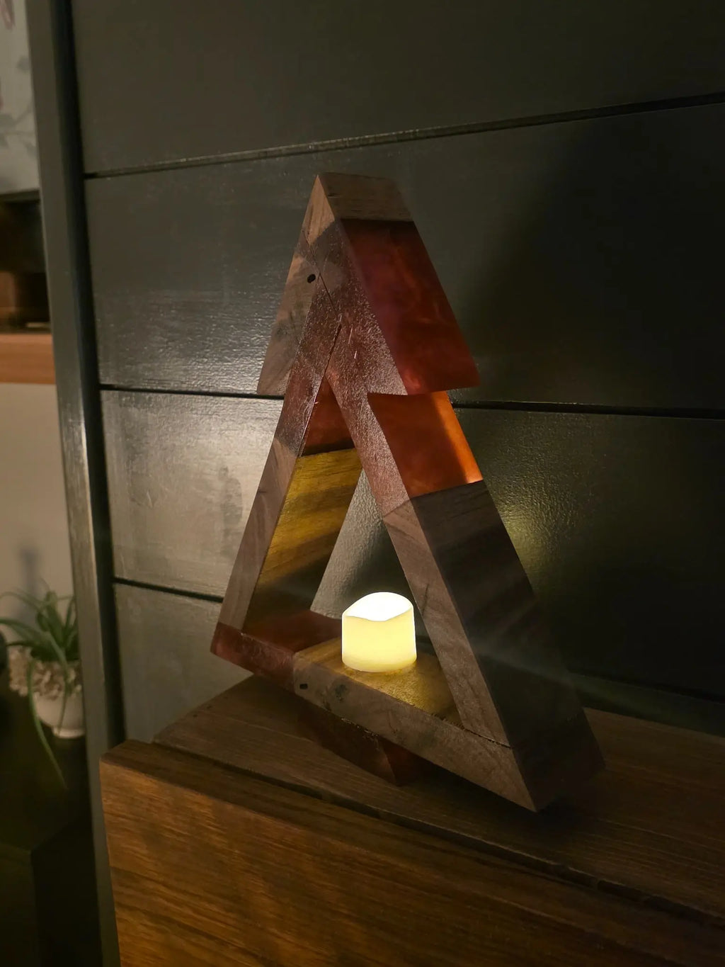 Side view of freestanding walnut and red resin Christmas tree