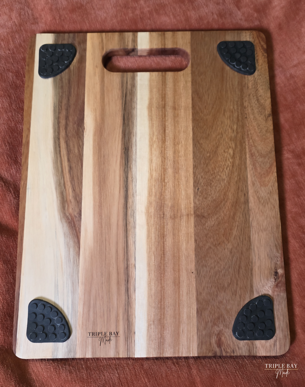 Back of Woodland Stag acacia board showing four feet and maker mark
